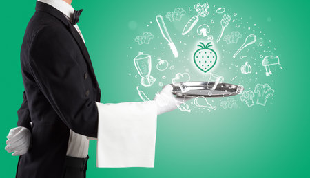 Waiter holding silver tray with food icons aboveの写真素材