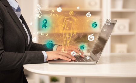 Doctor working on laptop with healthcare conceptの写真素材