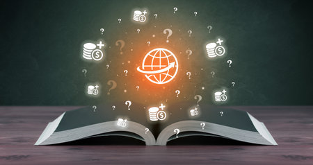 Open book with business icons aboveの写真素材