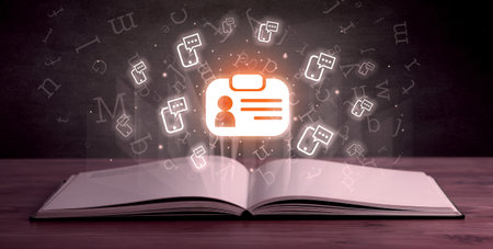 Open book with social networking icons aboveの写真素材