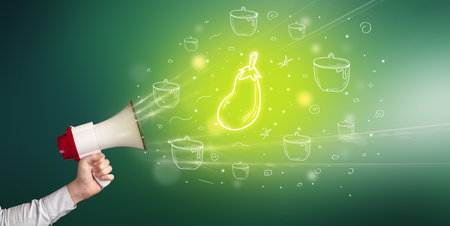 Young person with megaphone and healthy food iconの写真素材