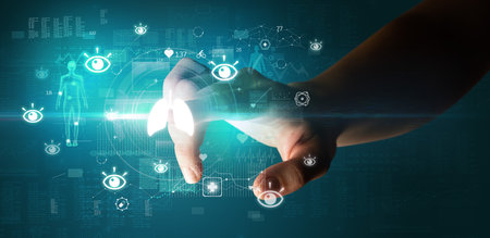 Doctor hand pressing futuristic health device with medical symbol on screenの写真素材