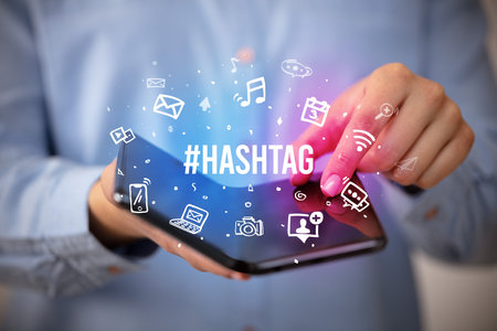 Businessman holding a foldable smartphone, social media concept concept conceptの写真素材
