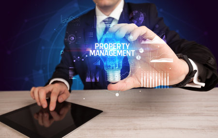 Businessman holding a light bulb, new business conceptの写真素材