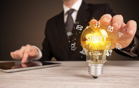 Businessman holding a light bulb, social media conceptの写真素材