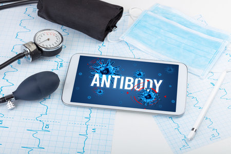 Tablet pc and doctor tools on white surfaceの写真素材