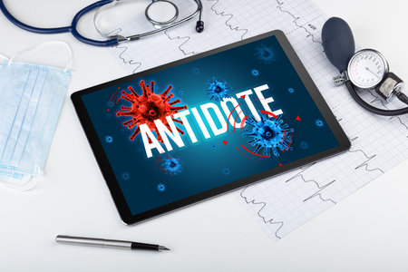 Tablet pc and doctor tools on white surfaceの写真素材