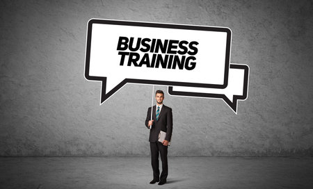 business person in casual holding road signの写真素材