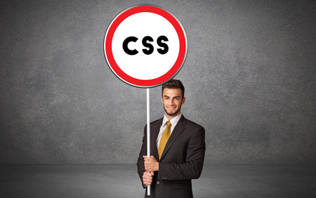 Young business person holdig traffic signの写真素材