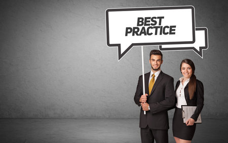 business person in casual holding road signの写真素材