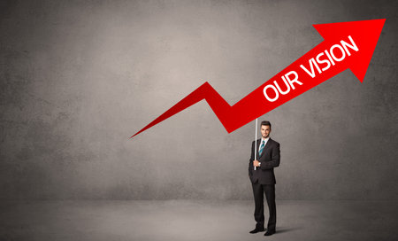 Young business person in casual holding road signの写真素材