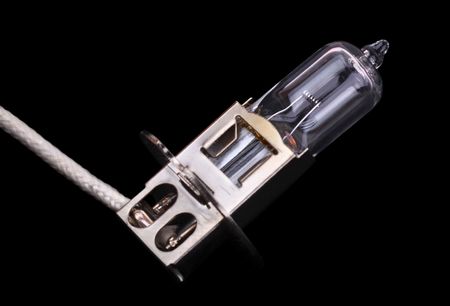 Electric light bulb for car headlights on a black backgroundの写真素材