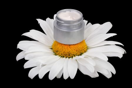Pie natural cosmetic cream of daisies. Isolated object on a black backgroundの写真素材
