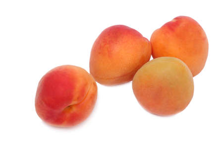 Four ripe apricot on a white backgroundの写真素材