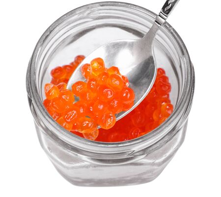 Red caviar on a silver spoon. Colorkey. Isolated on white.の写真素材