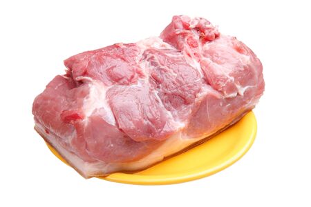 Fresh raw meat on a yellow plate isolated on whiteの写真素材