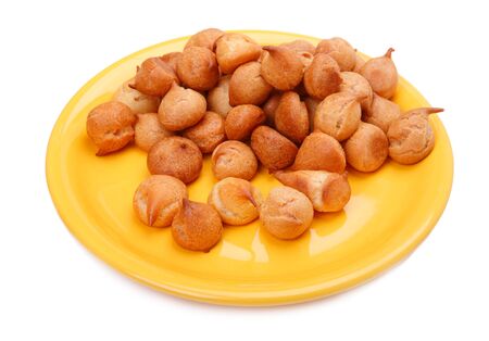 Small white bread on a yellow plate isolated on a white backgroundの写真素材