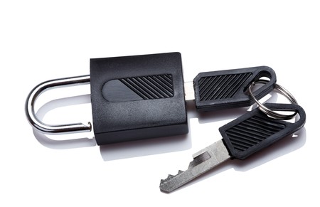 Padlock with key isolated on a white background with reflectionの写真素材