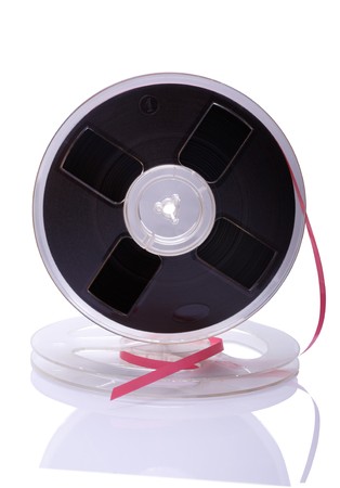 A vintage Reel-To-Reel of audio tape on a white background with reflectionの写真素材
