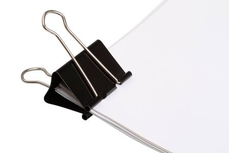 Large paper clip on blank papers isolated on white backgroundの写真素材
