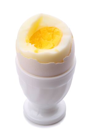 Single egg in cup isolated on white backgroundの写真素材