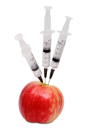 Red apple and three syringe isolated on white backgroundの写真素材