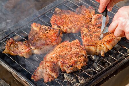 Preparation of grilled meat on hot charcoalの写真素材