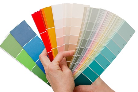 Hands on choosing color swatches. Color chart book. Isolated on white backgroundの写真素材