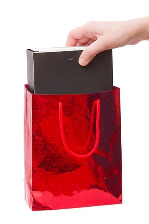 Hand gets the gift of Shopping Bag. Isolated on white backgroundの写真素材