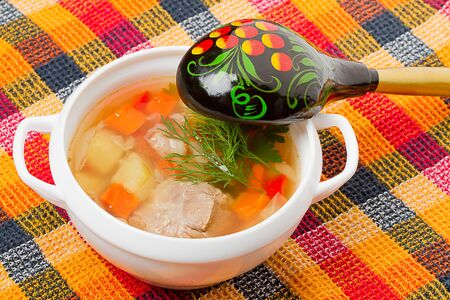 Soup in a white bowl and wooden spoon. Russian Cultureの写真素材
