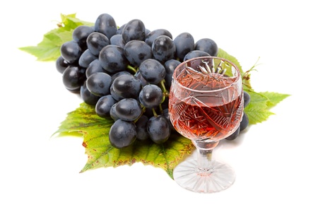 Blue grapes and red wine isolated on white backgroundの写真素材