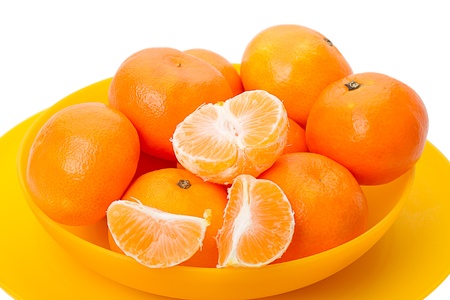 Mandarin orange in a yellow bowl. Isolated on a white backgroundの写真素材