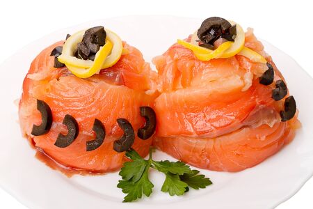 Decorated with two portions of salmon on white plateの写真素材