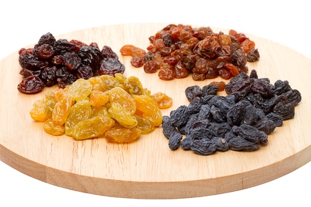 Four variety of raisins on cutting boardの写真素材
