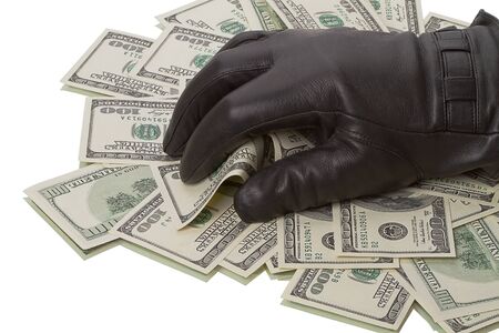Heap dollars and hand in a black glove isolated on white backgroundの写真素材
