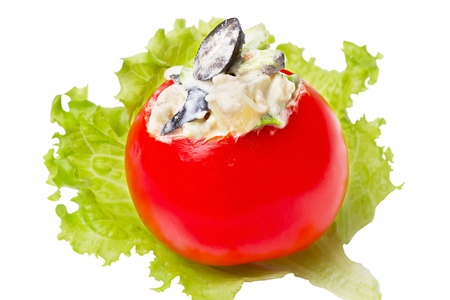 Stuffed tomato on a green leaf salad isolated on white backgroundの写真素材