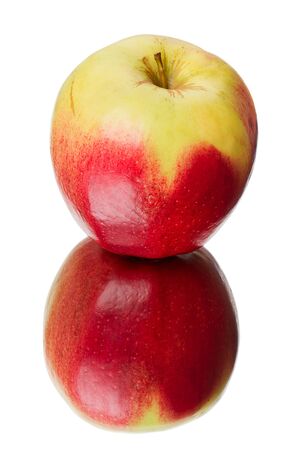 Apple with a red side on the mirror isolated on a white backgroundの写真素材