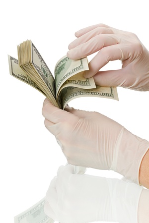 Hands in surgical gloves, consider the money. Isolated on white backgroundの写真素材