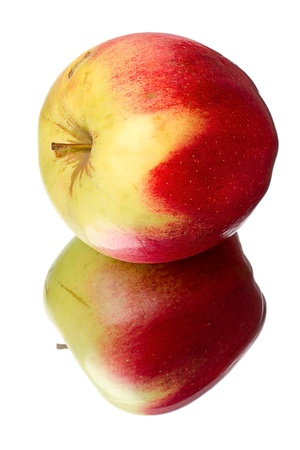 Apple lying on its side on the mirror isolated on a white backgroundの写真素材