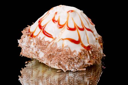 The original birthday cake with caramel isolated on a black backgroundの写真素材