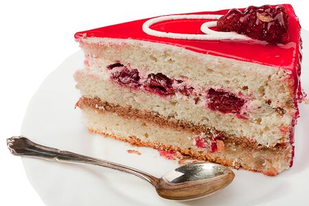 Sliced fruit cake on white plate. Isolated on a white background.の写真素材
