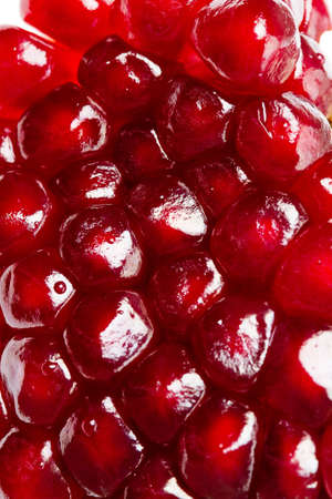 Background of ripe grains pomegranate on whiteの写真素材