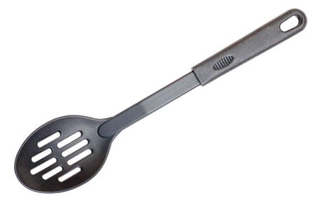 Special kitchen spoon of black nylon isolated on white backgroundの写真素材