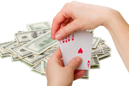Royal flush in the hands of and paper us currency  Isolated on white backgroundの写真素材
