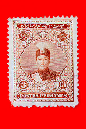 Old Iranian postage stamp with a picture of Shah Ahmed, 1923  Red background の写真素材
