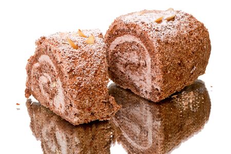 Roll the cake on a mirror isolated on a white background.の写真素材
