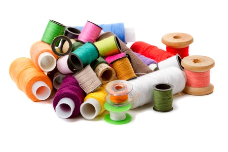 Heap spools of sewing threads isolated on a white backgroundの写真素材