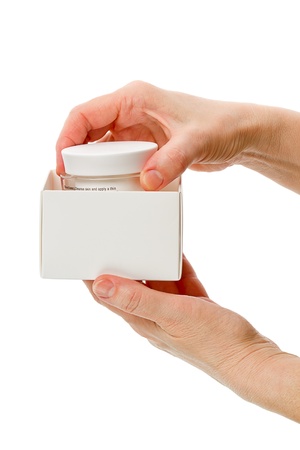 Box of cosmetics cream in their hands. Isolated on white backgroundの写真素材
