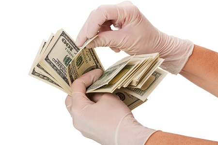 Hands in surgical gloves, consider the money  Isolated on white backgroundの写真素材