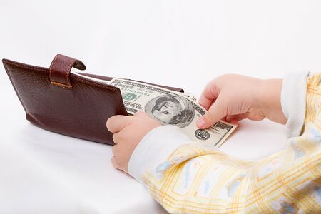 Wallet with dollars and hands the child on white backgroundの写真素材